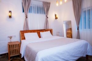 Bright king-size bedroom with garden windows at Villa Buffalo Downstairs