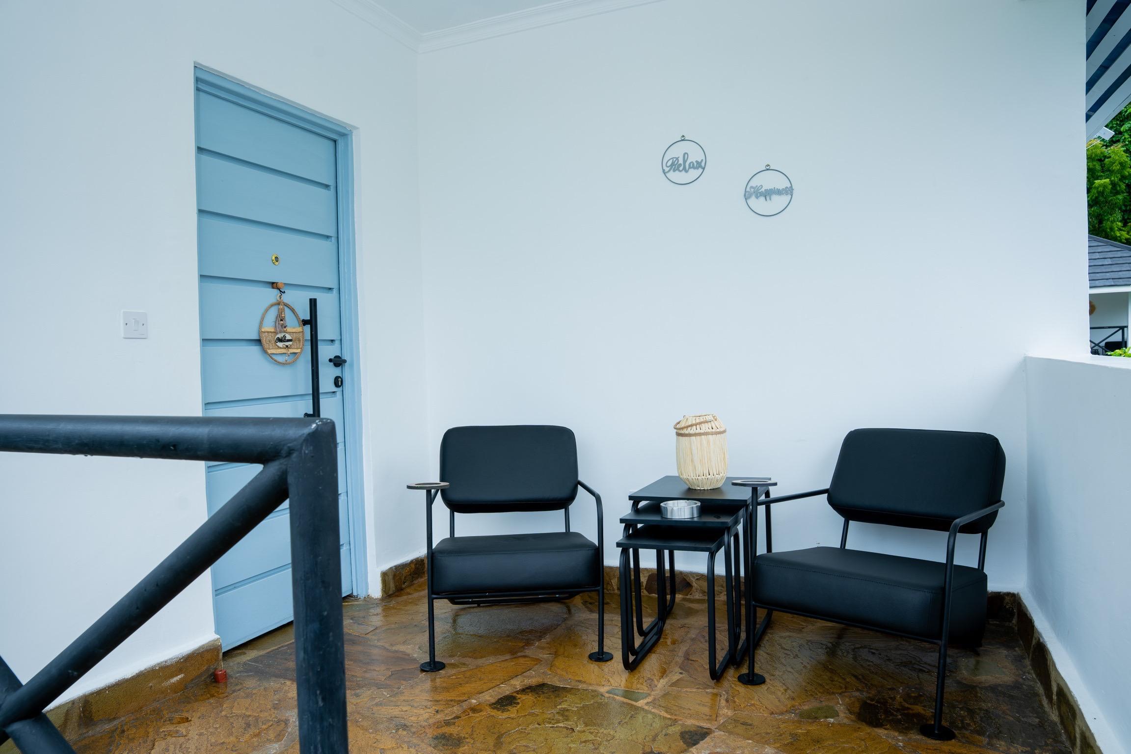 Private entrance balcony with seating at Villa Buffalo Upstairs