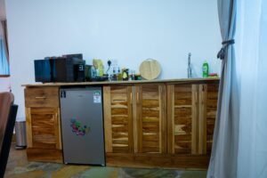 Wooden kitchenette with fridge at Villa Buffalo Upstairs