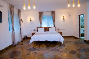 King-size bed and pendant lighting at Villa Buffalo Upstairs