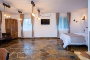 Bedroom with television and wooden wardrobe at Villa Buffalo Upstairs