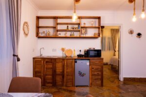 Wooden kitchenette with fridge at Villa Komba Upstairs