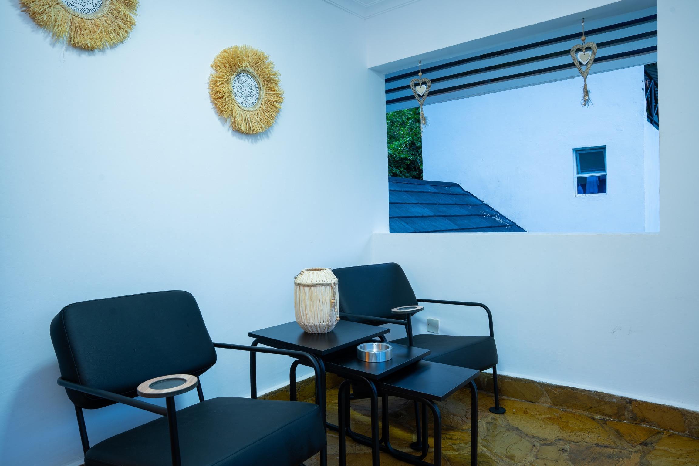 Private upper-floor terrace seating at Villa Komba Upstairs