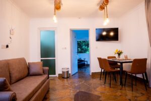 Living room with sofa and dining area at Villa Komba Upstairs