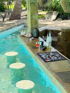 Pool bar counter and submerged seats at Coast Sun Gardens