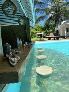 Swim-up pool bar and submerged seats at Coast Sun Gardens