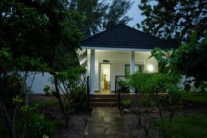 Garden path to the illuminated entrance of House Rhino