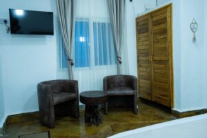 Bedroom seating, television and wardrobe at House Rhino